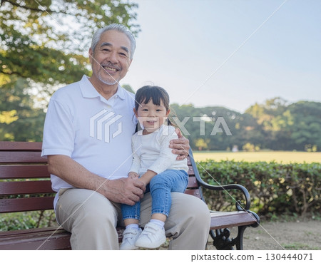 Happy grandfather with grandson on his lap 130444071