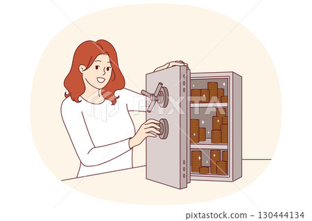 Woman accumulates capital by putting gold coins in safe to become rich and independent 130444134