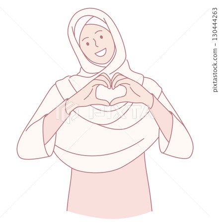 A Joyful Woman Wearing a Hijab Making a Heart Shape Gesture with Her Hands Exuding Happiness 130444263