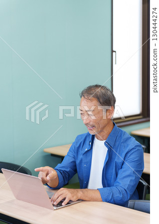 Senior men using laptops Senior men using laptops 130444274
