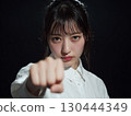 女人用力揮舞拳頭 | 力量、戰鬥和決心的象徵 130444349