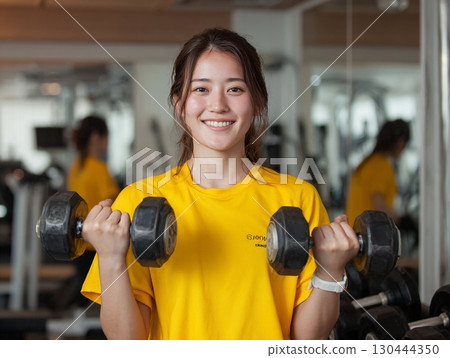 Smiling woman training with dumbbells | Fitness, health Smiling woman training with dumbbells | Fitness, health 130444350