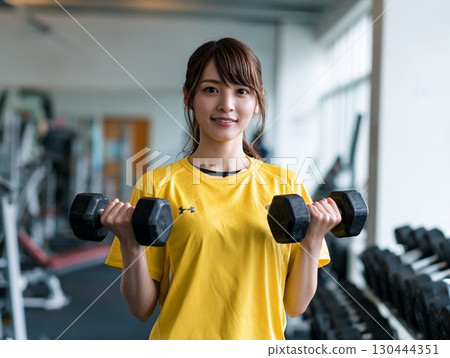 Smiling woman training with dumbbells | Image of health and fitness 130444351
