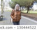 Senior woman walking in park contemplating life 130444522