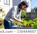 A woman enjoying a family garden 130444607
