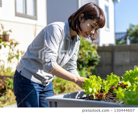 A woman enjoying a family garden 130444607
