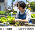 A woman enjoying a family garden 130444609