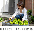 A woman enjoying a family garden 130444610
