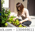 A woman enjoying a family garden 130444611