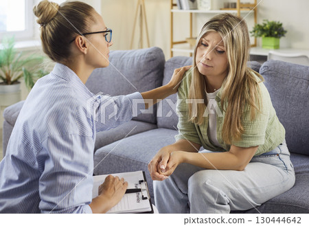 Psychologist consoling patient, gentle reassurance and support in counseling 130444642
