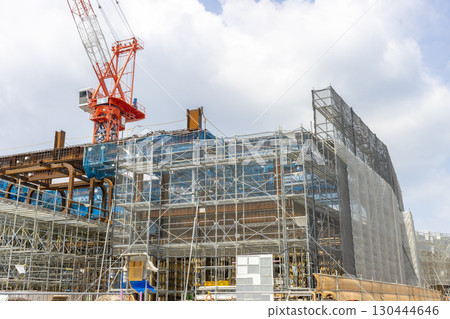 Climbing crane and building under construction. Image of a construction site Climbing crane and building under construction. Image of a construction site 130444646
