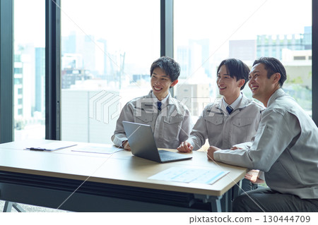 A man in work clothes having a meeting A man in work clothes having a meeting 130444709
