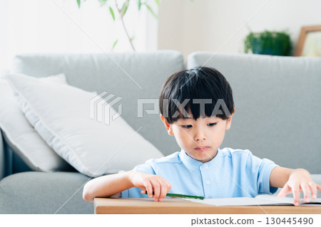 Elementary school boy studying in the living room 130445490