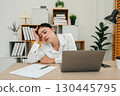 bored woman working with laptop computer at home office 130445795