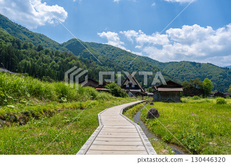Wooden path crossing traditional village of Shirakawa-go in Japan 130446320
