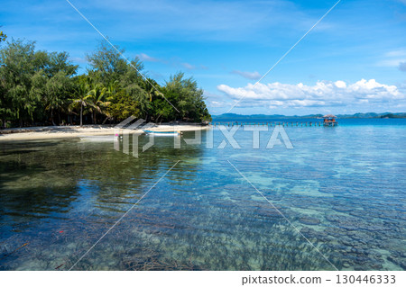 Wooden jetty and boat at Bolilanga Island, Togian archipelago, Sulawesi, Indonesia Wooden jetty and boat at Bolilanga Island, Togian archipelago, Sulawesi, Indonesia 130446333