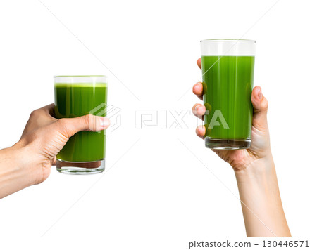 Close-up of hand holding fresh green smoothie with spinach, healthy lifestyle choice isolated 130446571