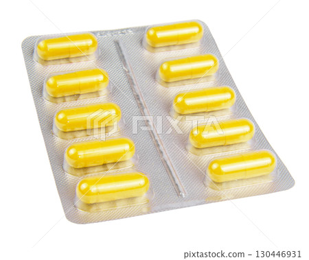 Yellow pills in the blister pack, isolated on white 130446931