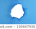Hole in paper color background damaged ripped 130447930