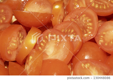 Close up of lots of chopped baby cherry tomatoes for background Close up of lots of chopped baby cherry tomatoes for background 130448086
