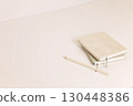 Beige and green notebooks and color pencil on minimal desk 130448386