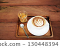 White coffee cup and bael tea on brown wooden table 130448394