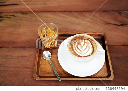 White coffee cup and bael tea on brown wooden table 130448394