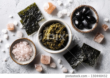 Seaweed spread with olives and salt on textured surface 130448432
