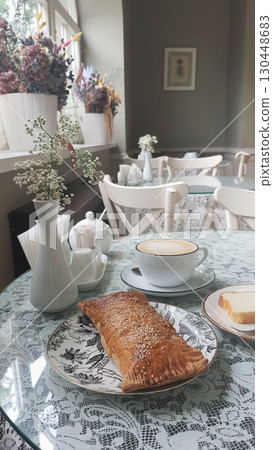 Elegant cafe setting with fresh pastry and coffee during a quiet morning Elegant cafe setting with fresh pastry and coffee during a quiet morning 130448683