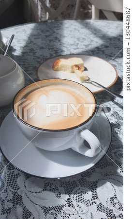 Delightful coffee experience with dessert on a lace table 130448687