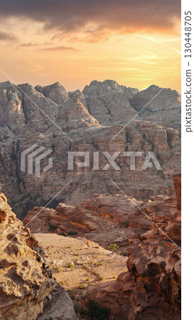 Stunning sunset over rugged mountain landscape in a remote desert region. Petra, Jordan. 130448705
