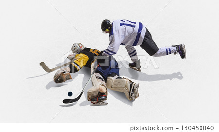 Top angle hockey goalkeeper stretched on ice colliding with rival player 130450040