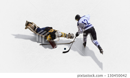 Aerial top view hockey goalkeeper diving across ice to stop rival with desperation 130450042