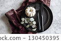 Elegant thanksgiving table setting with mini pumpkin and velvet napkin 130450395