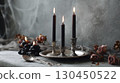 Elegant gothic candle arrangement with dark roses and silver accents 130450522