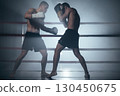 Two shirtless muscular man fighting Kick boxing combat in boxing ring. 130450675
