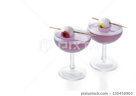 Purple Halloween cocktail garnished with candy eye Purple Halloween cocktail garnished with candy eye 130450903