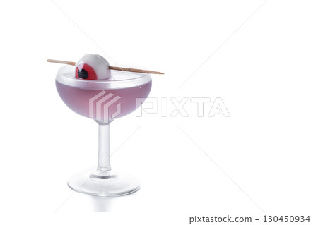 Purple Halloween cocktail garnished with candy eye 130450934