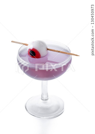 Purple Halloween cocktail garnished with candy eye Purple Halloween cocktail garnished with candy eye 130450973