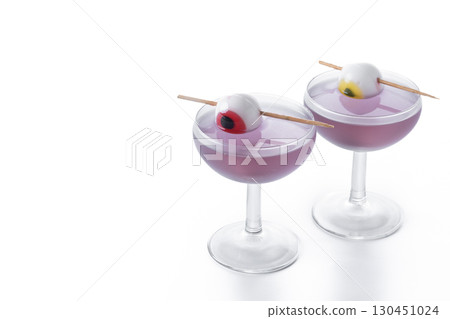 Purple Halloween cocktail garnished with candy eye 130451024
