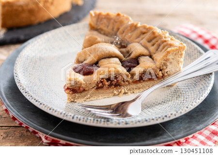 : Slice of traditional Pastafrola pie with guava filling, also known as Cuban pae on rustic wooden table. 130451108