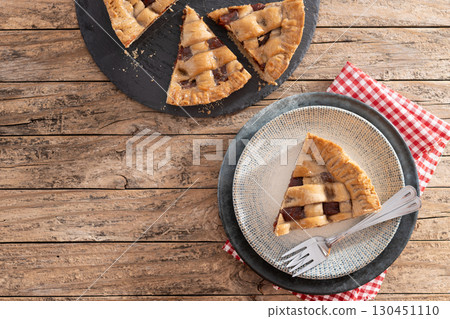 : Slice of traditional Pastafrola pie with guava filling, also known as Cuban pae on rustic wooden table. : Slice of traditional Pastafrola pie with guava filling, also known as Cuban pae on rustic wooden table. 130451110