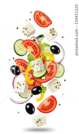 Tomato, cucumber, onion, yellow bell pepper, black olives, and herb-coated cheese cubes float in mid-air surrounded by scattered pepper. Ingredients appear fresh and vibrant 130451320