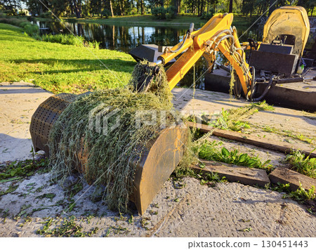 excavator's bucket was covered in algae excavator's bucket was covered in algae 130451443