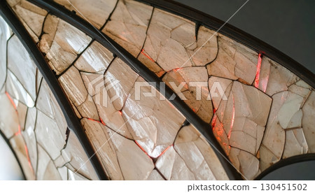 Close up bat wing texture with cracks and glowing light inside, mysterious design pattern for Halloween atmosphere, fantasy element of dark magical creature 130451502