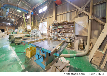 A table saw and organized storage shelves in a woodworking shop A table saw and organized storage shelves in a woodworking shop 130451631