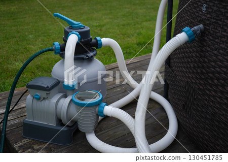 The equipment pump that supports filtration and ozone disinfection for an outdoor swimming pool. 130451785