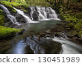 A waterfall leading to the Kikuchi Gorge with a clear stream flowing through nature 130451989