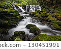 A waterfall leading to the Kikuchi Gorge with a clear stream flowing through nature 130451991