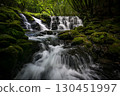 A waterfall leading to the Kikuchi Gorge with a clear stream flowing through nature 130451997